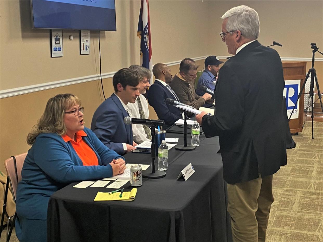 Candidate forum moderator David Lisle checks with school board candidate April Ferrao about how to pronounce her name on January 24, 2023, in Columbia, Mo.