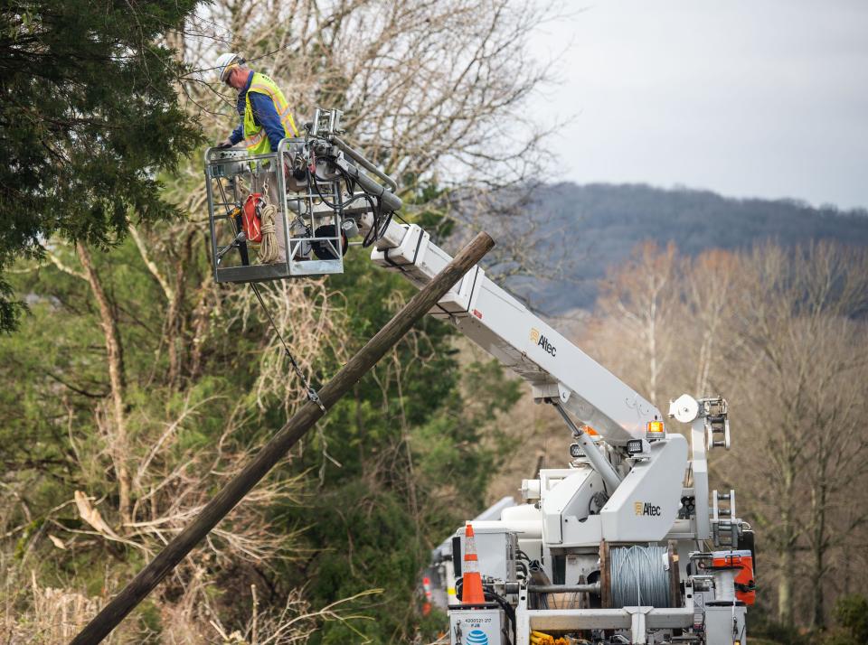 Workers repair damaged power lines in Harstville.