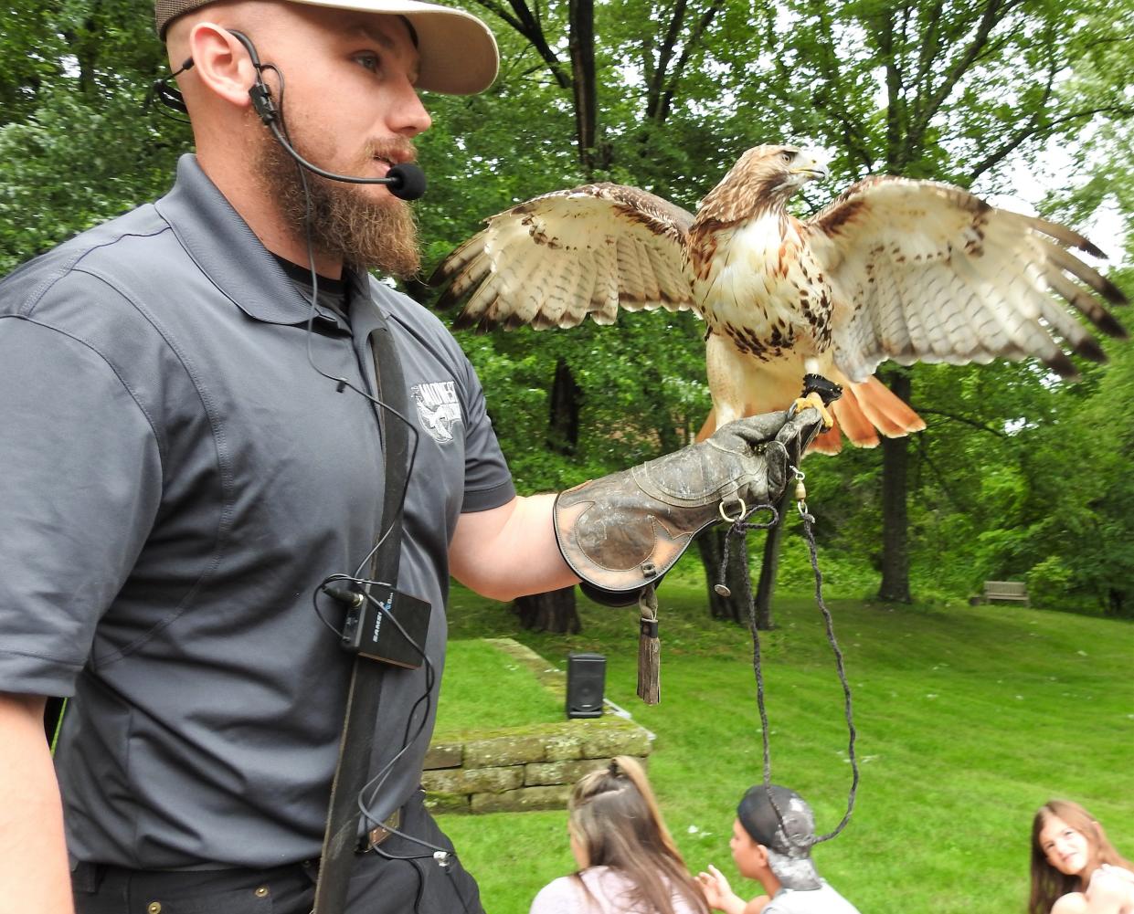 Adam McGuire of Midwest Falconry from outside Cincinnati with one of the birds of prey brought for a presentation recently at Clary Gardens. They had falcons, owls and hawks.