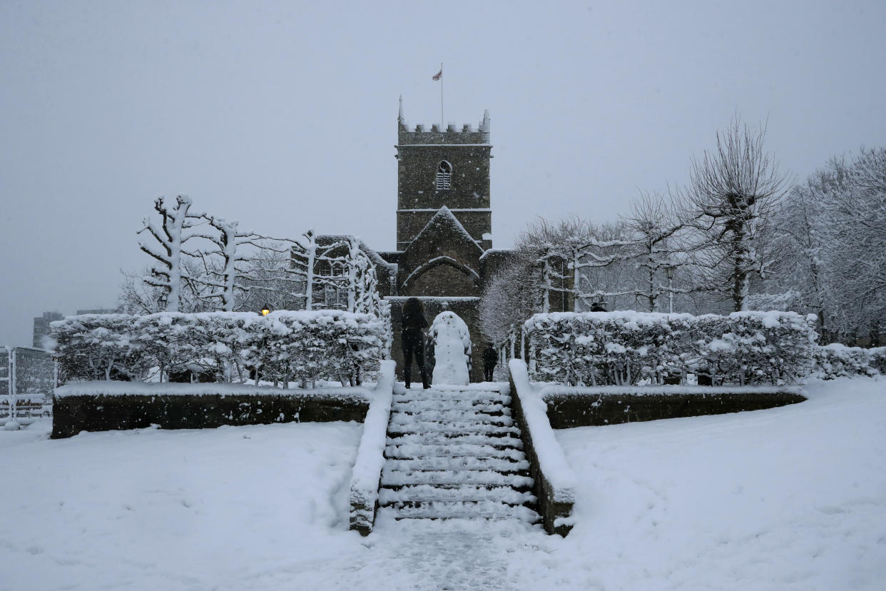 Snow falls over St Peter's Church in Bristol, south west England, Friday, Feb. 1, 2019. (AP Photo/Matt Dunham)