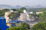 Smokes rise from an LG Polymers plant following a gas leak incident in Visakhapatnam on May 7, 2020. - At least five people have been killed and several hundred hospitalised after a gas leak at a chemicals plant on the east coast of India, police said on May 7. They said that the gas had leaked out of two 5,000-tonne tanks that had been unattended due to India's coronavirus lockdown in place since late March. (Photo by - / AFP) (Photo by -/AFP via Getty Images)