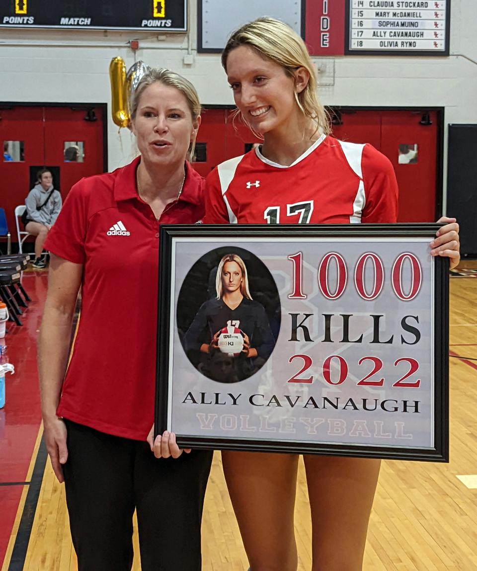 Bishop Kenny head volleyball coach Suzanne Winkler (left) presents senior outside hitter Ally Cavanaugh with a plaque recognizing her 1,000th career kill after  a high school volleyball match against Bolles on September 8, 2022. [Clayton Freeman/Florida Times-Union]