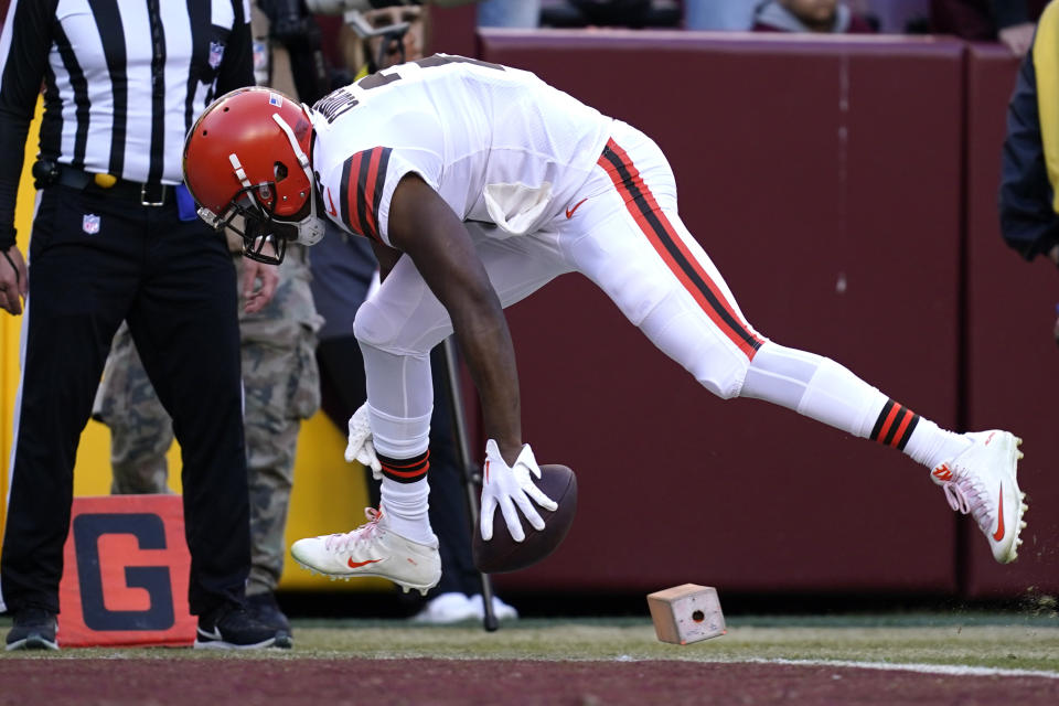 Cleveland Browns wide receiver Amari Cooper (2) knocks the pylon over as he scores a touchdown during the second half of an NFL football game against the Washington Commanders, Sunday, Jan. 1, 2023, in Landover, Md. (AP Photo/Patrick Semansky)