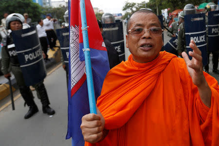 REFILE - CORRECTING NAME A Buddhist monk and supporter of opposition Cambodia National Rescue Party (CNRP) takes part in a march to deliver petition to the parliament and King Norodom Sihamoni to intervene in ther country's current political crisis in Phnom Penh, Cambodia May 30, 2016. REUTERS/Samrang Pring