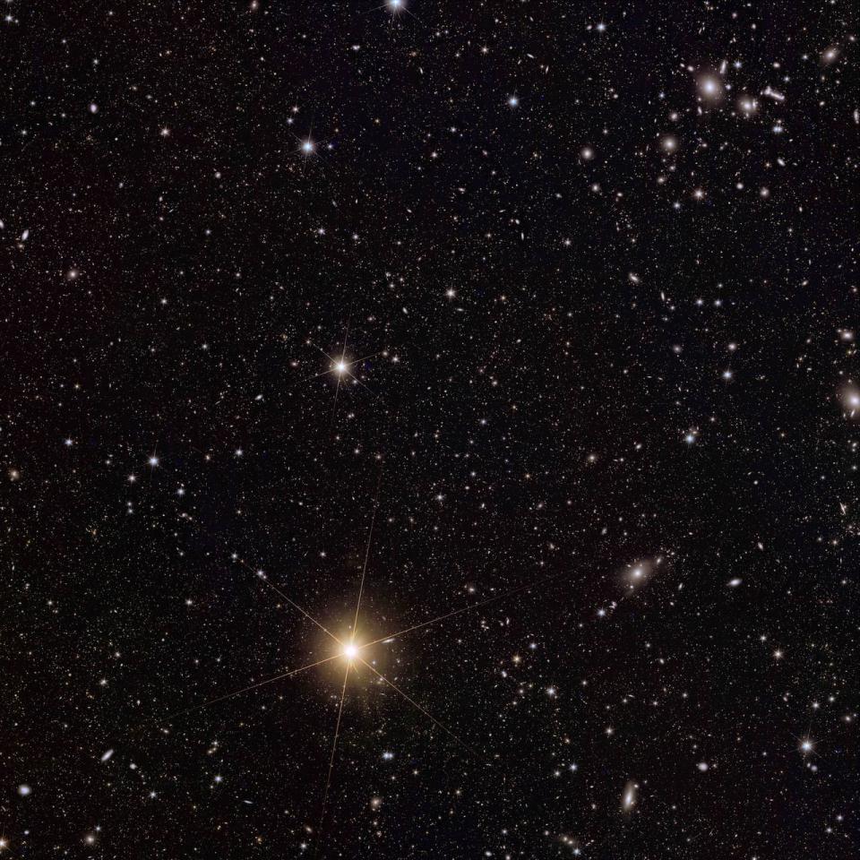 This image shows the galaxy cluster Abell 2764 (top right), a very dense region of space with hundreds of galaxies orbiting in a halo of dark matter.  Euclid captures a range of objects in this patch of sky, including many background galaxies, more distant clusters of galaxies, interacting galaxies that have thrown out streams and shells of stars, and a beautiful spiral at the edge that allows us to see the 'thinness ' to see.  from his disk.