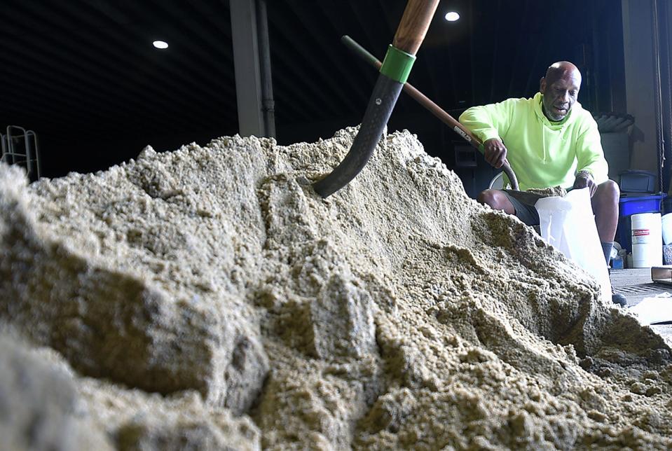 Fall River Department of Community Management worker Levi Souza-Young fills a sandbag that will be made available to the public Friday Sept. 15, 2023.