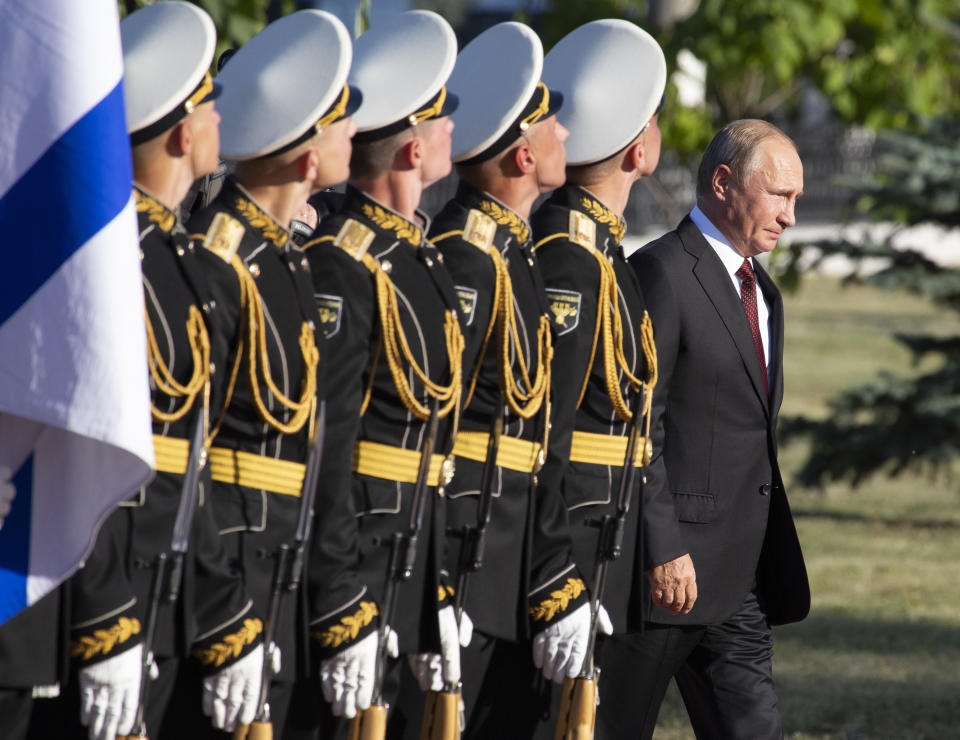 Russian President Vladimir Putin, right, arrives to attend a laying ceremony in Kursk, 426 kilometers (266 miles) south of Moscow, Russia, Thursday, Aug. 23, 2018. Putin attends a ceremony marking the 75th anniversary of the battle of Kursk in which the Soviet army routed Nazi troops. It is described by historians as the largest tank battle in history involving thousands of tanks. (AP Photo/Alexander Zemlianichenko, Pool)