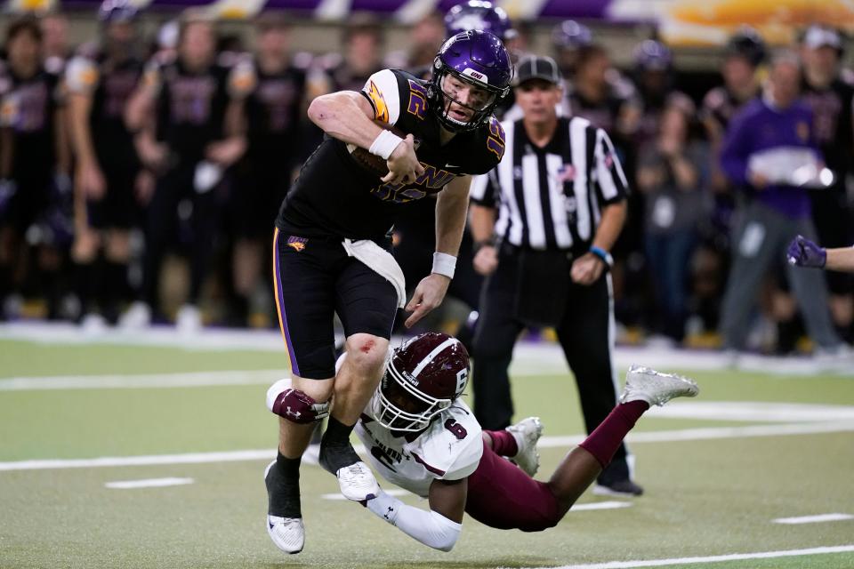 Northern Iowa quarterback Theo Day (12) tries to break a tackle by Southern Illinois safety Jakari Patterson (6) during the second half of an NCAA college football game, Saturday, Oct. 30, 2021, in Cedar Falls, Iowa. Northern Iowa won 23-16.