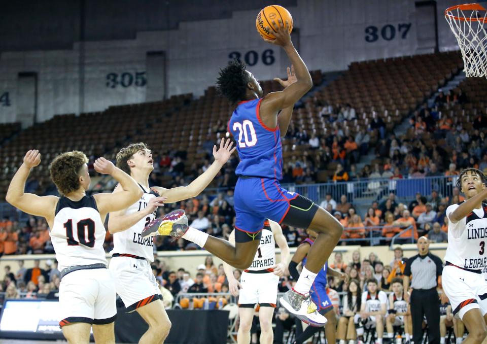 Millwood's Jaden Nickens goes to the basket in between Lindsay's Ty Ferguson (10) and Andon Register (24) on Thursday during the Class 3A state quarterfinals at State Fair Arena.