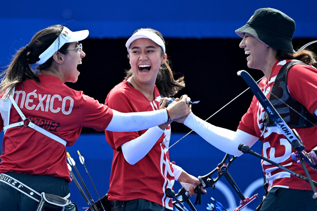 (fromL) Mexico's Ana Vazquez, Mexico's Angela Ruiz and Mexico's Alejandra Valencia react during the archery Women's team quarterfinal during the Paris 2024 Olympic Games at the Esplanade des Invalides in Paris on July 28, 2024. (Photo by Punit PARANJPE / AFP) (Photo by PUNIT PARANJPE/AFP via Getty Images)