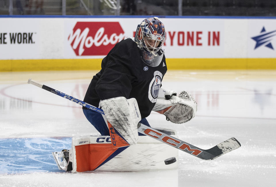 Edmonton Oilers' goalie Stuart Skinner (74) makes a save during NHL hockey practice, Wednesday June 12, 2024, in Edmonton, Alberta. The Oilers host the Florida Panthers in Game 3 of the Stanley Cup Finals on Thursday. (Jason Franson/The Canadian Press via AP)