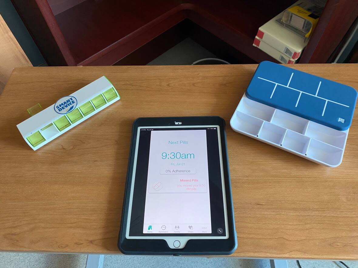 Teaching patients how to use smart pillboxes is part of the learning modules at the Stan Cassidy Centre in Fredericton. This gadget help participants track when and what pills to take using a smartphone or tablet.  (Submitted by Emma Croken - image credit)