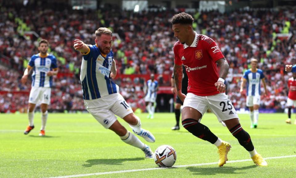 Jadon Sancho of Manchester United is put under pressure by Alexis Mac Allister of Brighton