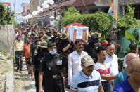 In this photo provided by the Indian Army, the coffin containing the remains of Chandra Shekhar, an Indian army soldier found more than 38 years after he went missing, is brought to his hometown in Haldwani, India, Wednesday, Aug. 17, 2022. The soldier and 17 other colleagues were occupying a ridge on Siachen Glacier, high in the Karakoram range in disputed Kashmir's Ladakh region, in May 1984 when they were hit by an avalanche, officials said. (Indian Army via AP)