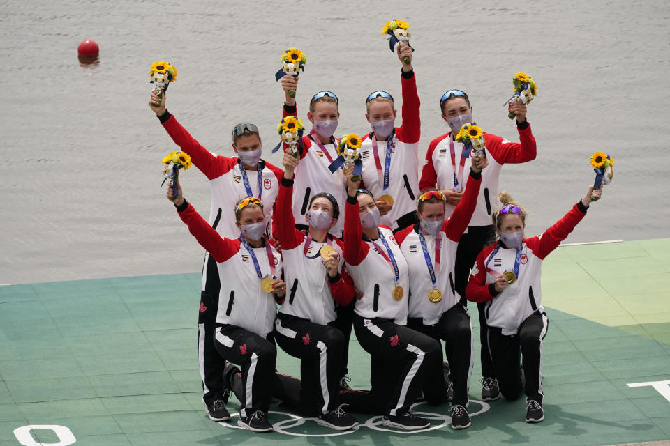 Lisa Roman, Kasia Gruchalla-Wesierski, Christine Roper, Andrea Proske, Susanne Grainger, Madison Mailey, Sydney Payne, Avalon Wasteneys and Kristen Kit of Canada celebrate winning the gold medal in the women's rowing eight final at the 2020 Summer Olympics, Friday, July 30, 2021, in Tokyo, Japan. (AP Photo/Darron Cummings)