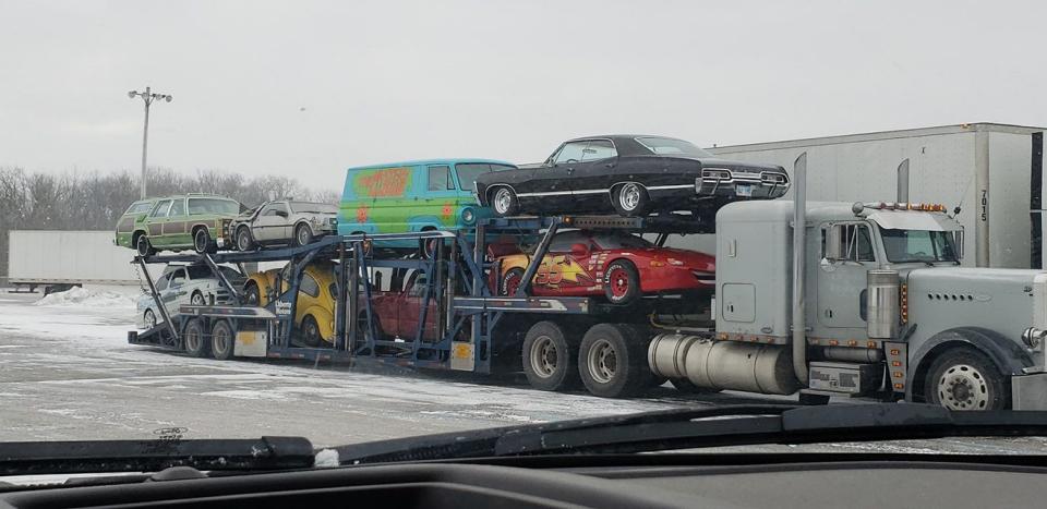 <p>Reader Travis Webb sent us this behind-the-scenes photo of some movie cars on a transporter, including the Family Truckster, the Delorean, the Mystery Machine, and Bumblebee. Were these the cars from the ad? Perhaps not, but it's a fun coincidence nonetheless.</p>