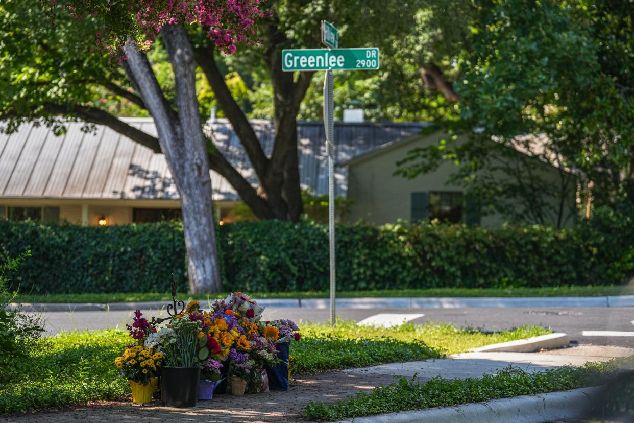 A makeshift memorial stands Sunday near the intersection of Greenlee and Hillview in Austin's Tarrytown neighborhood where Allison Baker and her husband, lawyer Steve Baker, were struck Thursday by a vehicle while on a walk.