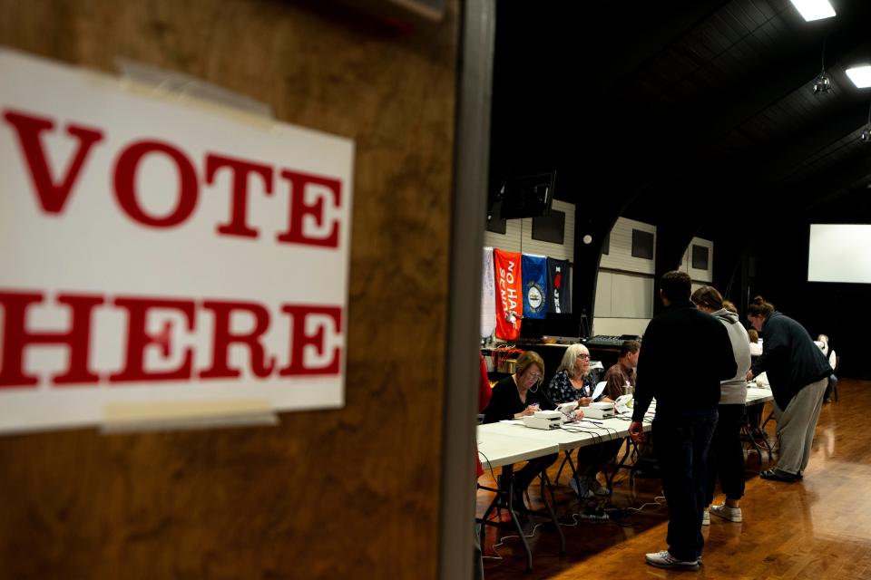 Poll workers check in voters on Election Day at Lakeside Christian Church in Lakeside Kentucky.