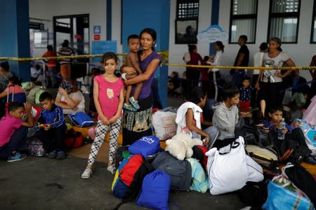 The Wider Image: Venezuelan mothers, children in tow, rush to migrate