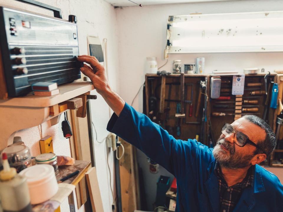 Carpenter at the workshop plays the radio: Getty