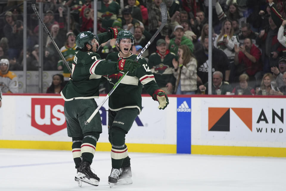 Minnesota Wild left wing Matt Boldy, right, celebrates with defenseman Brock Faber after scoring during the third period of an NHL hockey game against the Nashville Predators, Thursday, Jan. 25, 2024, in St. Paul, Minn. (AP Photo/Abbie Parr)