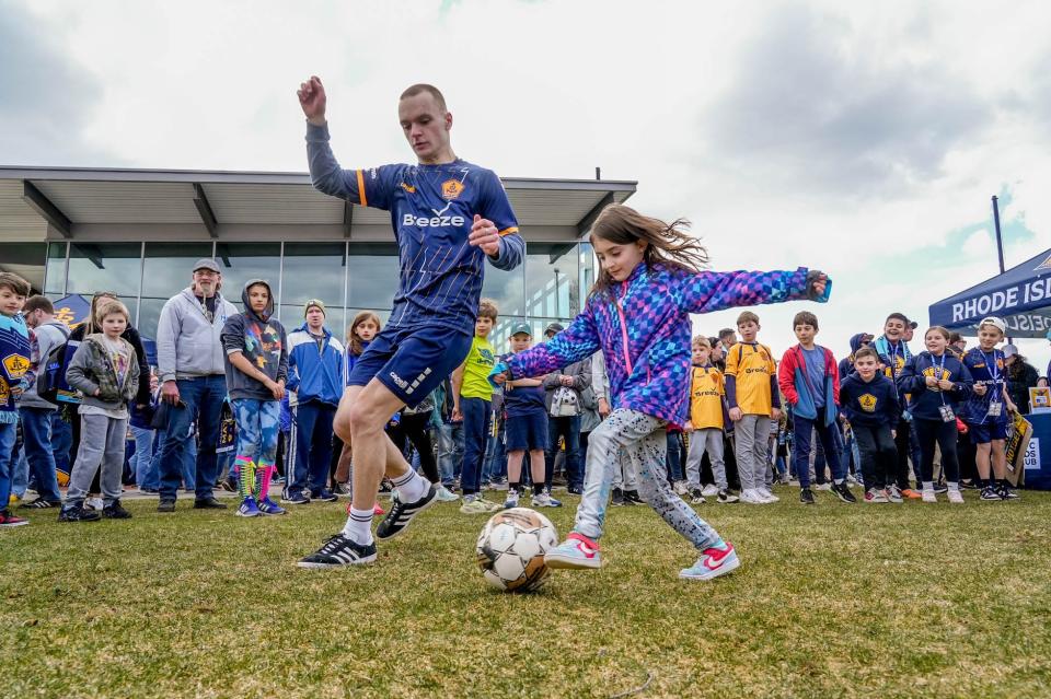 Sofia Soares, of Cumberland, kicks the ball around with a player from Freestyle Soccer before Saturday's debut game for Rhode Island FC at Bryant University's Beirne Stadium.