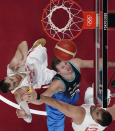 Slovenia's Luka Doncic, center, goes to the basket between Spain's Victor Claver, left, and Marc Gasol, right, during a men's basketball game at the 2020 Summer Olympics, Wednesday, July 28, 2021, in Saitama, Japan. (Brian Snyder/Pool Photo via AP)