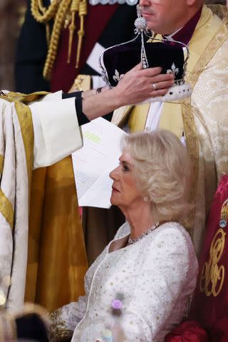 <p>Richard Pohle - WPA Pool/Getty Images</p> Queen Camilla is crowned by Archbishop of Canterbury Justin Welby on May 6.