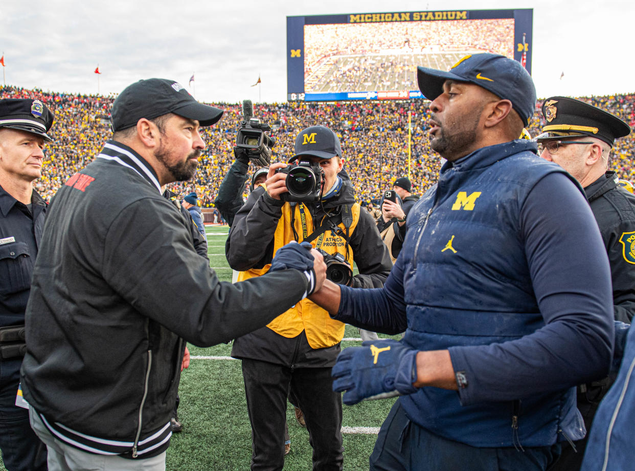 Ohio State coach Ryan Day (left) shakes hands with Michigan coach Sherrone Moore on Saturday after the Wolverines' win over the Buckeyes. (Aaron J. Thornton/Getty Images)