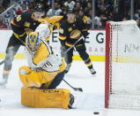 Nashville Predators goaltender Juuse Saros (74) stops a shot from Vancouver Canucks centre Elias Pettersson (40) during second period NHL hockey action in Vancouver, Monday, Feb. 10, 2020. (Jonathan Hayward/The Canadian Press via AP)