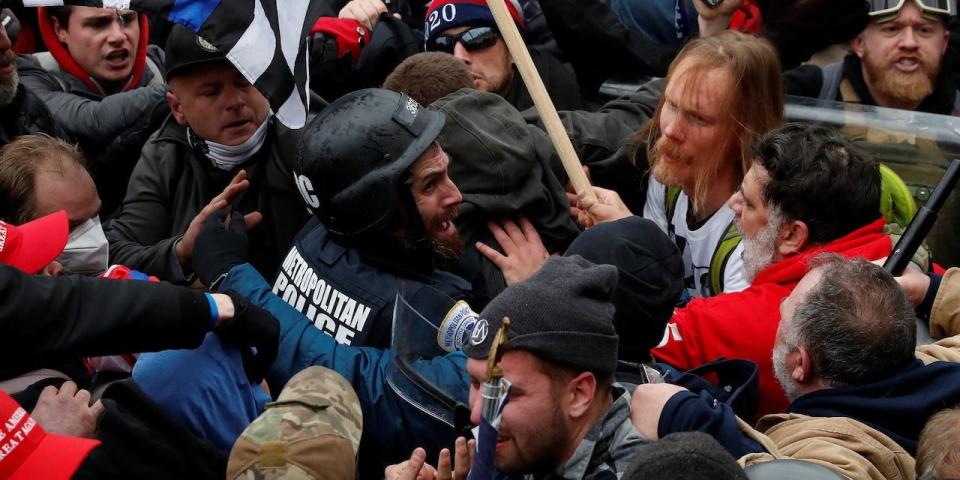 Pro-Trump protesters surround and assault D.C. police officer Michael Fanone during the Capitol riot on Jan. 6, 2021.