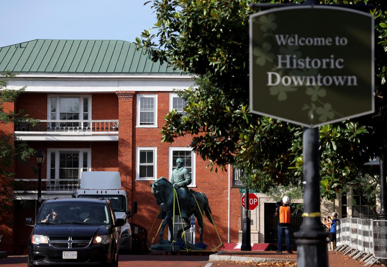 A flatbed truck carries a statue of Confederate General Robert E. Lee from the Market Street Park July 10, 2021 in Charlottesville, Virginia.