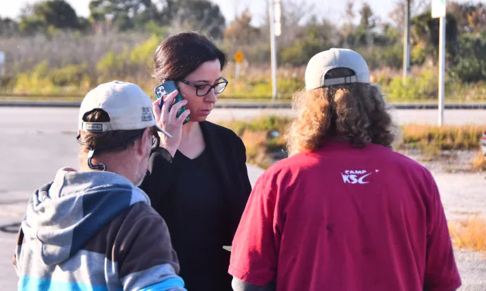 Attorney Jessica J. Travis with DefendBrevard.com was out at a homeless camp early Wednesday Dec. 8, 2021, to help the people living in the camp who face being arrested if they leave. Residents of the homeless camp off of U.S. 192 near Melbourne are facing a tough problem. They are being evicted from the property but the camp is their official address, and they can&#39;t leave the property or they will be violating their probation or parole. Many wear ankle bracelets or have GPS monitors.