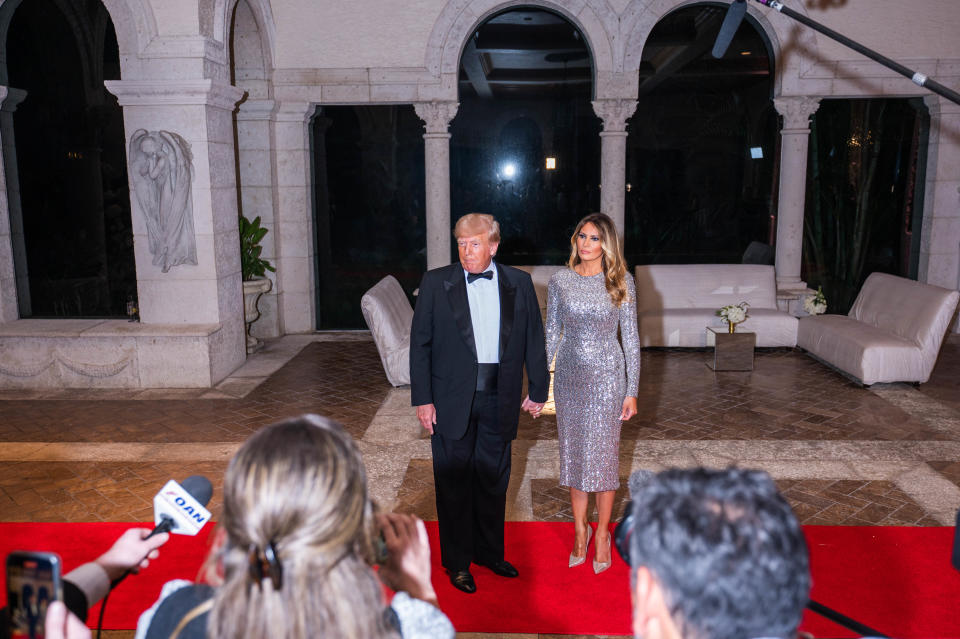 Former President Donald Trump and his wife, Melania, stop to speak to the media at Mar-a-Lago on New Year's Eve.