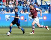 Apr 30, 2016; Montreal, Quebec, CAN; Montreal Impact midfielder Ignacio Piatti (10) plays the ball and Colorado Rapids defender Bobby Burling (23) defends during the first half at Stade Saputo. Mandatory Credit: Eric Bolte-USA TODAY Sports