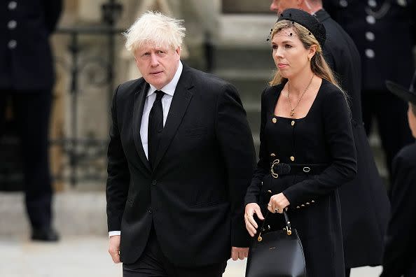 LONDON, ENGLAND - SEPTEMBER 19: Former Prime Minister of the United Kingdom Boris Johnson and Carrie Johnson arrive at Westminster Abbey ahead of The State Funeral of Queen Elizabeth II at Westminster Abbey on September 19, 2022 in London, England. Elizabeth Alexandra Mary Windsor was born in Bruton Street, Mayfair, London on 21 April 1926. She married Prince Philip in 1947 and ascended the throne of the United Kingdom and Commonwealth on 6 February 1952 after the death of her Father, King George VI. Queen Elizabeth II died at Balmoral Castle in Scotland on September 8, 2022, and is succeeded by her eldest son, King Charles III.  (Photo by Christopher Furlong/Getty Images)