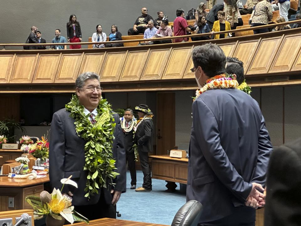 Hawaii Senate President Ron Kouchi, left, speaks to senators at the Hawaii State Capitol on Wednesday, Jan. 17, 2024, in Honolulu. Hawaii lawmakers on Wednesday opened a new session of the state Legislature vowing to address glaring problems laid bare by the deadly wildfire that destroyed the historic town of Lahaina in August: the threat posed by wildfires and the lack of affordable housing. (AP Photo/Audrey McAvoy)