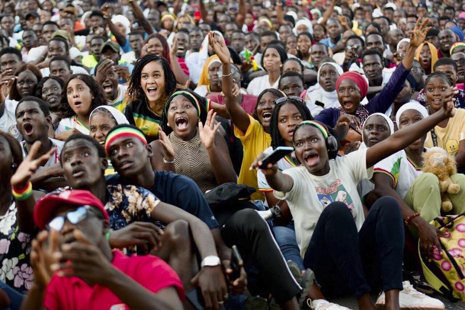 Senegal soccer fans react as they watch their team on a large screen at a fan zone in the UCAD University in Dakar, Senegal, Monday Nov. 21, 2022, during the World Cup Group B soccer match between Senegal and Netherlands. (AP Photo/Sylvain Cherkaoui)