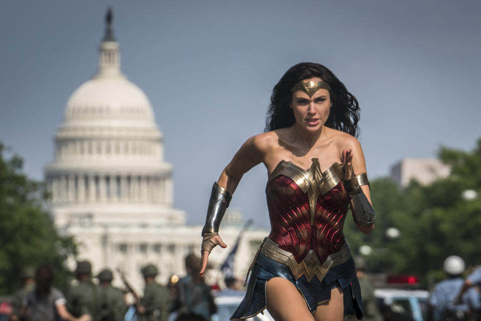 This image released by Warner Bros. Pictures shows Gal Gadot as Wonder Woman in a scene from "Wonder Woman 1984." The film isn't skipping theaters or moving to 2021, but it is altering course. The last big blockbuster holdout of 2020 is still opening in U.S. theaters on Christmas Day but it will also be made available to HBO Max subscribers free of charge for its first month, Warner Bros. said Wednesday, Nov. 18, 2020. (Clay Enos/Warner Bros Pictures via AP)