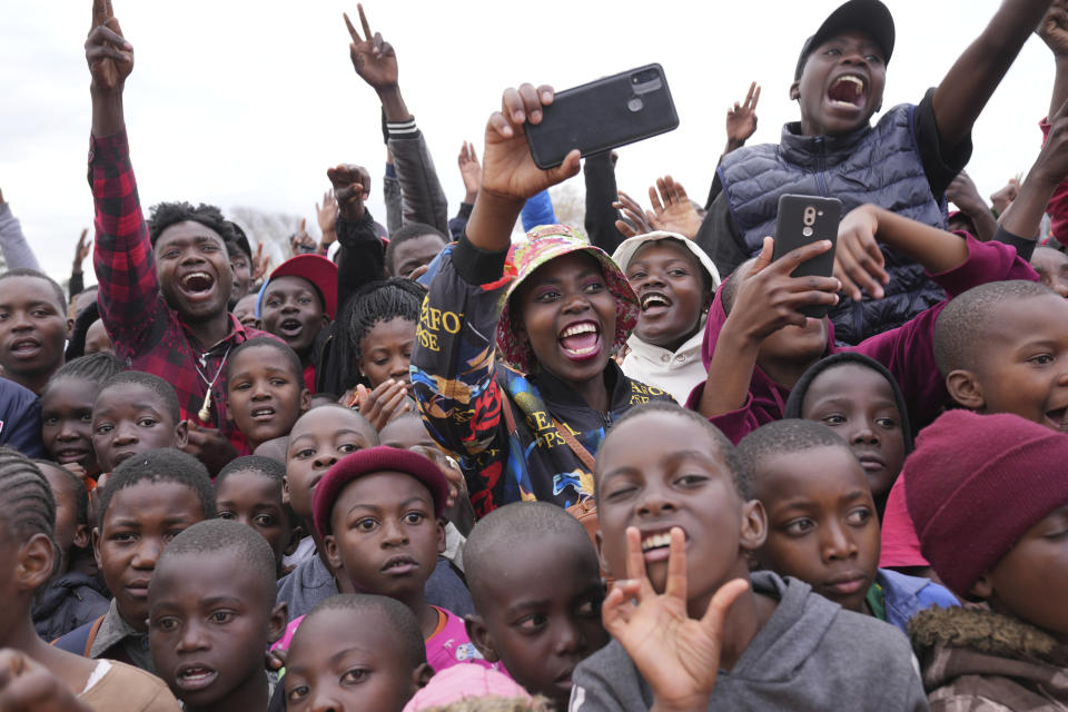 A group of fans react after seeing U.S boxing promoter and former professional boxer Floyd Joy Mayweather at an event on the outskirts of the capital Harare, Zimbabwe Thursday, July 13 2023. Mayweather is in the country for what he is calling the Motherland Tour. (AP Photo/Tsvangirayi Mukwazhi)