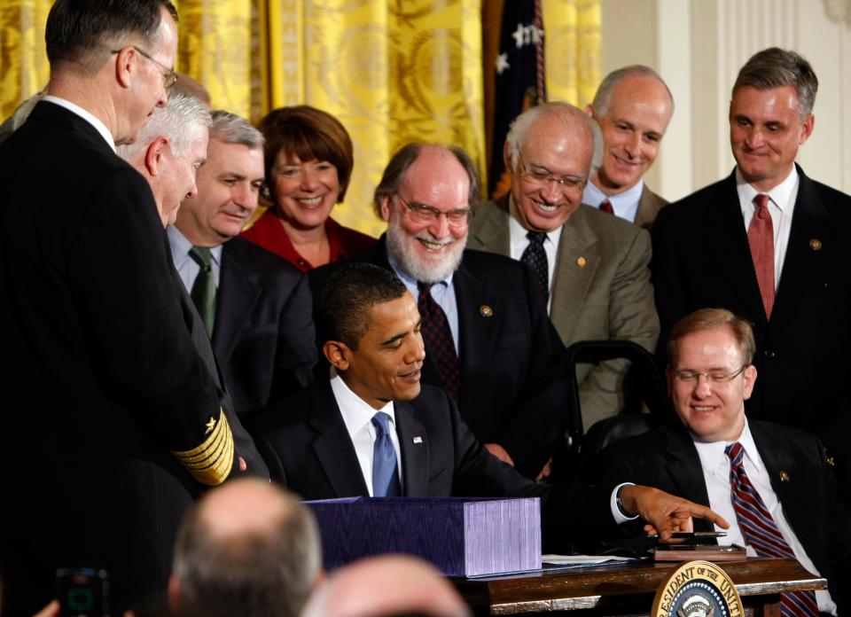 Rep. Jim Langevin, right, looks on as President Barack Obama signs the National Defense Authorization Act for Fiscal Year 2010, Oct. 28, 2009, in the East Room of the White House.