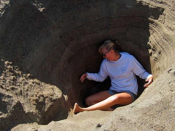 stuck in a hole in the sand digging dug dig debt