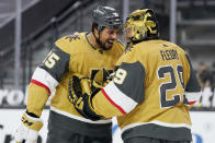 Vegas Golden Knights goaltender Marc-Andre Fleury, right, celebrates after right wing Ryan Reaves, left, scored against the San Jose Sharks, during the third period of an NHL hockey game Wednesday, March 17, 2021, in Las Vegas. (AP Photo/John Locher)