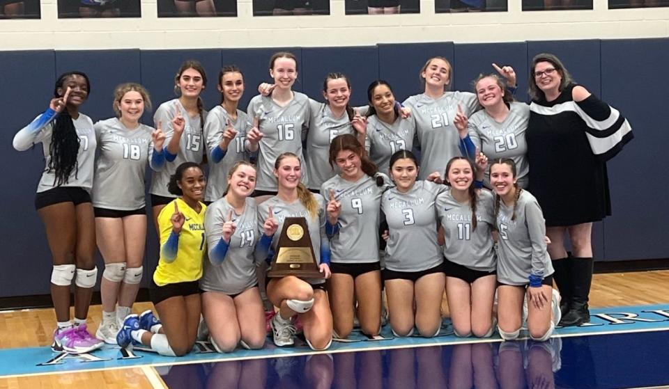 The McCallum volleyball team poses with the District 24-5A title after defeating Ann Richards on Tuesday at Ann Richards School.