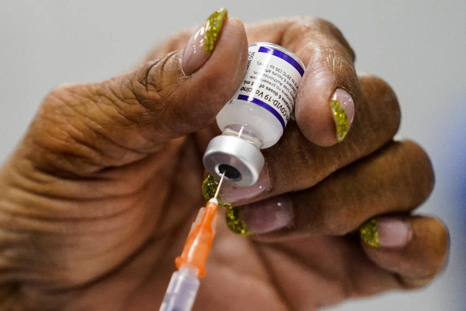 A syringe is prepared with the Pfizer COVID-19 vaccine at a vaccination clinic at the Keystone First Wellness Center in Chester, Pa., Wednesday, Dec. 15, 2021. (AP Photo/Matt Rourke)