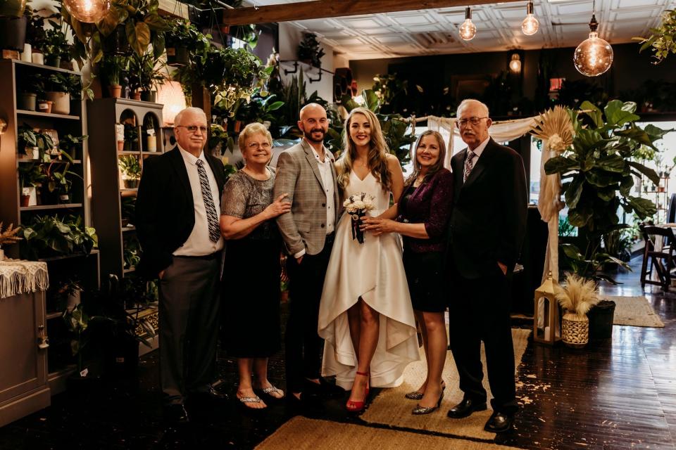 Inside The Conservatory in downtown Monroe, the newly married Mr. and Mrs. Nathaniel Turner, center, stand with their parents, John Turner Sr. and his wife, Pat, left, and Judith and Michael Boberg Sr.