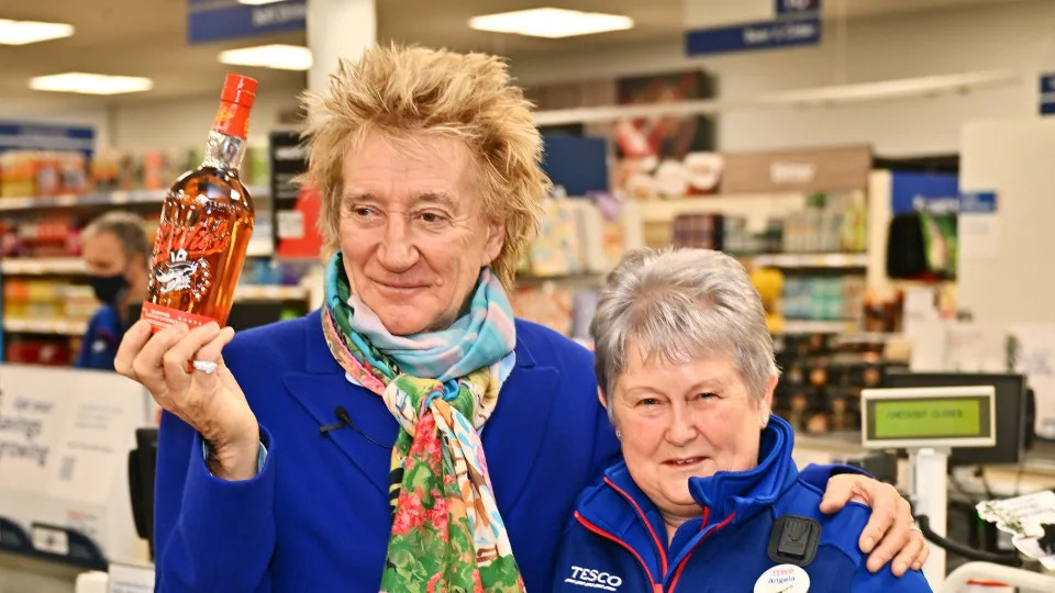 Sir Rod Stewart (L) visits his local Tesco in Bishop's Stortford to celebrate Wolfie's Whisky now being available to buy in more than 400 Tesco stores across the UK on January 30, 2024 in London, England.