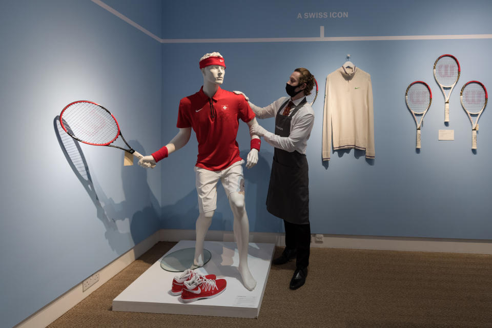 <p>LONDON, UNITED KINGDOM - JUNE 21: A staff member stands next to Roger Federer's signed champion outfit and racket from 2014 Davis Cup (est. Â£20,000-30,000) during a photo call for 'The Roger Federer Collection: Sold to Benefit The RF Foundation' Evening and Online Sale at Christie's auction house in London, United Kingdom on June 21, 2021. The collection celebrates Federerâs historic achievements, with sporting memorabilia from his Grand Slam victories offered for auction in London on 23 June together with an online sale (23 June â 13 & 14 July), which chronicles his incredible career from the early 2000s right through to 2021. (Photo by Wiktor Szymanowicz/Anadolu Agency via Getty Images)</p>
