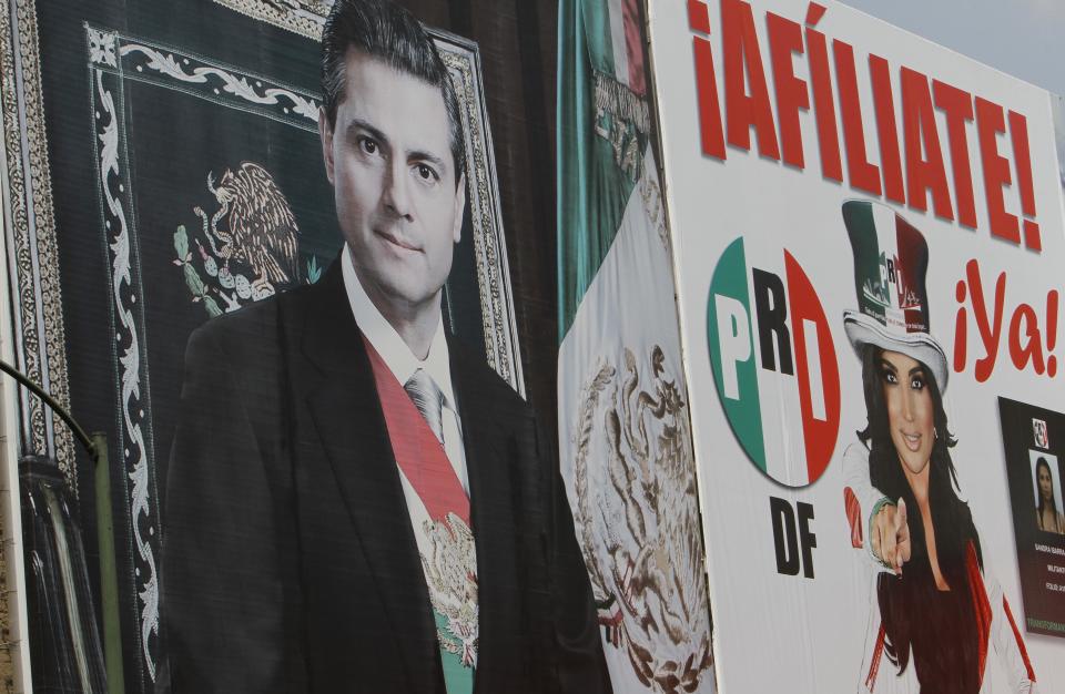 A sign promoting the Institutional Revolutionary Party (PRI) shows President Enrique Pena Nieto, left, and a woman at right under the words in Spanish "Sign up! Your party needs you." at the PRI headquarters for Mexico City, Wednesday, April 2, 2014. Cuauhtemoc Gutierrez, local political chief from Mexico's ruling party, the PRI, is denying local press reports that his office hired women to have sex with him by placing them on party payrolls as secretaries or receptionists. The MVS radio station says an undercover reporter recorded recruiters telling potential hires they would have to have sex with their boss. (AP Photo/Marco Ugarte)