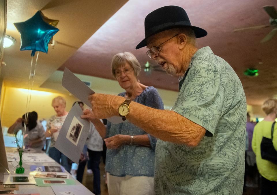 Ingrid and Jim Best look at memorabilia at the last reunion of former employees of the Stockton Developmental Center at the Cancun restaurant in downtown Stockton on Saturday, Oct. 8, 2022.